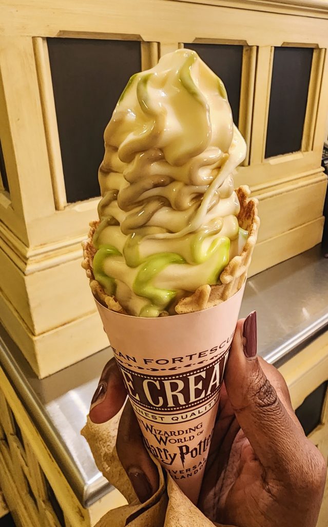 A cone filled high with toffee apple soft serve ice cream.