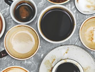 Assorted coffee cups on a marble background