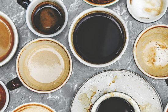 Assorted coffee cups on a marble background